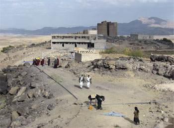 A typical scene in the rural areas outside Sanaa, where women do most of the work while their men get the privilege of being bosses. Photo by Nadia Strakova