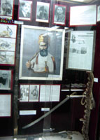 The center photo is of Ali Nasser Al-Qardi, the man who killed Imam Yahya Hamid Al-Din and his face signs. There is a story says that he fought a lion and he could kill it alone.