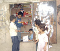 A moment for a business child when he is busy with his customers. He happily presents them with his goods.