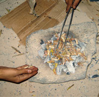 After removing the wings, locusts are placed on coal fire.
