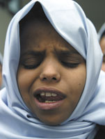 A blind student sings the national anthem with a belief she will be an active member in the future.