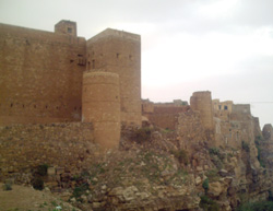 A huge wall encloses the ancient city of Kawkaban from one side, while natural barriers protect it from the other.