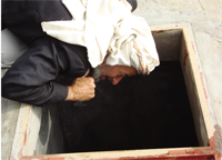 An old farmer checking the level of underground water in the farms well. There are areas in which the decline of the groundwater level is more than six meters a year.