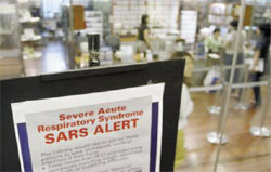 A medical advisory on the flu-like Severe Acute Respiratory Syndrome (SARS) is displayed at the entrance to a public library in Singapore, April 11. REUTERS