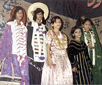 Girls appear in deeply-rooted traditional costumes