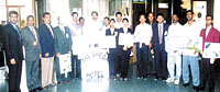 Staff volunteers greet the passengers with placards carrying messages to save water