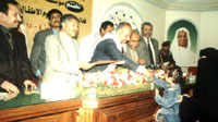 The panel (L-R)  Mr.Faez Saeed A. Saeed, Mr. Abdullah Abduh Saeed, Mr. Ahmed A. al-Hajri,  & Mr. Faisal S. Farae. The photo views the governor  honoring one of the children