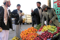 A  street vendor selling fruits to make a living amid harsh living conditions and rising prices. Most Yemenis believe that policies of the World Bank is the main cause behind worsening poverty and price hikes in Yemen. (Photo by Jamil Abdul Karim)