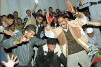 Palestinians look at the damaged car of Hamas leader, Abdel-Aziz al-Rantissi, after he was killed in Gaza April 17. An Israeli helicopter missile strike on a car in Gaza City killed top Hamas leader Abdel-Aziz al-Rantissi. REUTERS