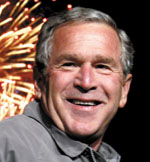Fireworks light up the sky as U.S. President George W. Bush smiles for  supporters at a campaign rally in Yardley, Pennsylvania, Oct. 28.   REUTERS