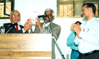 Mr A. Karuppaiyah, the Ambassador of India, formally releasing the book in the presence of Dr. Thakur as Dr. Sharma applauds