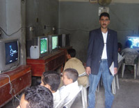 Some children and teens are busy playing video games inside one of the video game shops in Sana