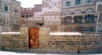The remains of the church from outside: a walled pit in an Old Sanaa neighborhood.